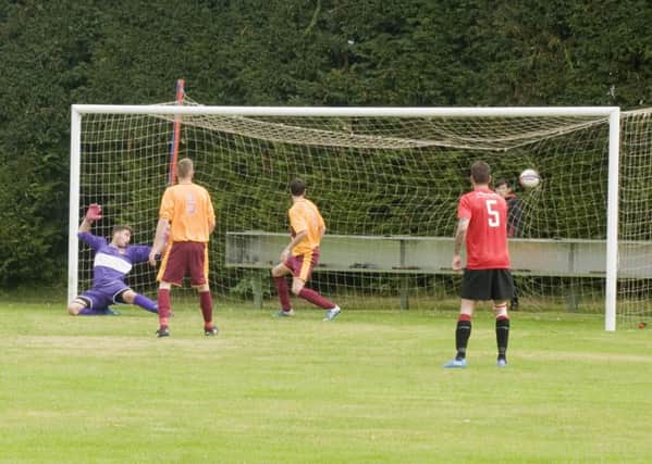 A goal for  Tayport (in red) against Whitburn (picture by Ron Nicol)