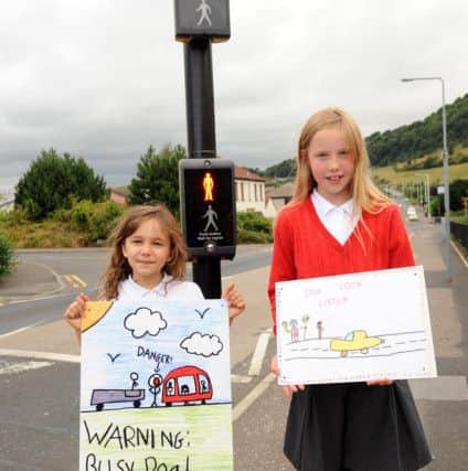 Sarah Fehr (9) and Farren Forrest (10) push the road safety message