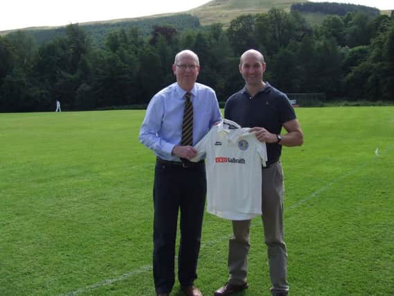 Dom Wedderburn of CKD Galbraith handing over the Falcon's new playing shirts to Robbie Nellies, FCC Youth Convenor.