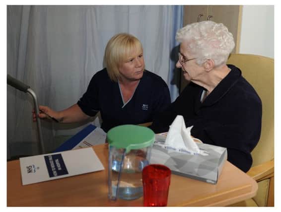 Senior staff nurse Helen Caithness does a comfort check with patient Isabella Caldwell.
