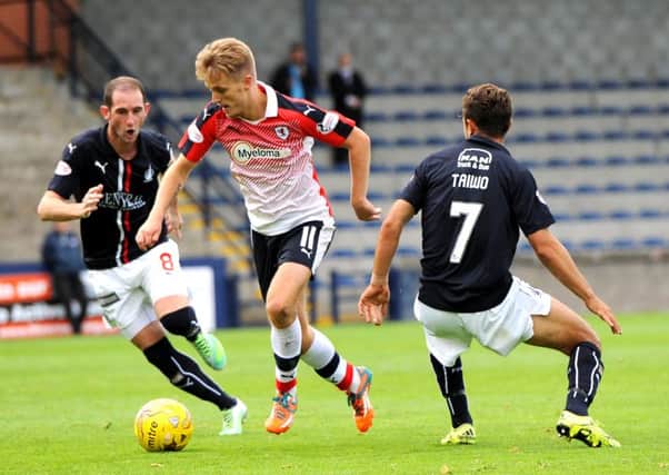 Bobby Barr embarks on a trademark run between two Falkirk opponents. Pic: Fife Photo Agency
