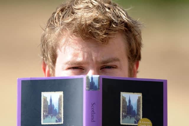 Crail poet Garry MacKenzie has won a top poetry prize. pic of him with some books down on one of the benches at the harbour. 21 Sept 16