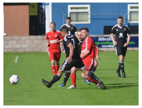 St Andrews, in black, were four goals behind at half time to a slick Sauchie. Pic by G McLuskie.
