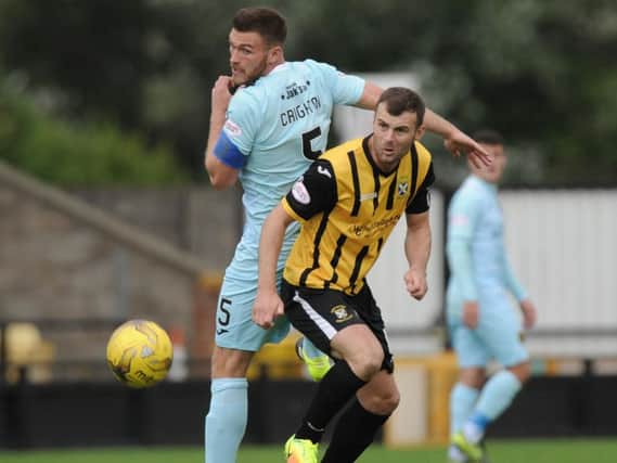 Kevin Smith battles for possession as the Fifers turn the screw. Picture by G McLuskie.