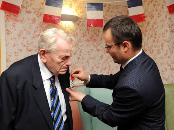 Louis is presented with his Legion d'honor medal by Emmanuel Cocher, Consul General de France. Pic: FPA.