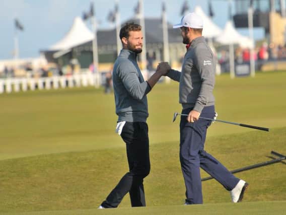 Jamie Dornan (left) congratulates playing partner Tyrrell Hatton after a birdie on the Road Hole. Hatton equalled the Old Course record of 62