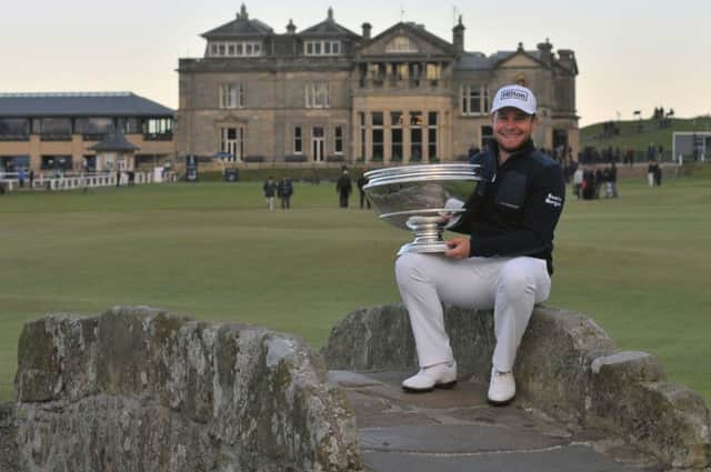 Tyrrell Hatton, Alfred Dunhill Links champion 2016, with the trophy on the Swilcan Bridge. Picture by John Stewart.