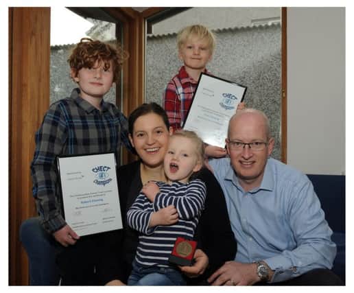 Euan and his big brother Robert with their parents, Robert and Ellen, and little sister Eilidh (Photo: George McLuskie)