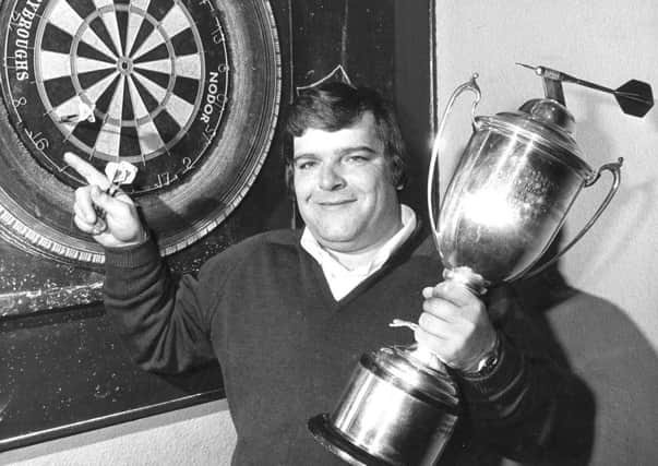 Jocky Wilson in Kirkcaldy with the Embassy Darts World Championship trophy after beating John Lowe in 1982.