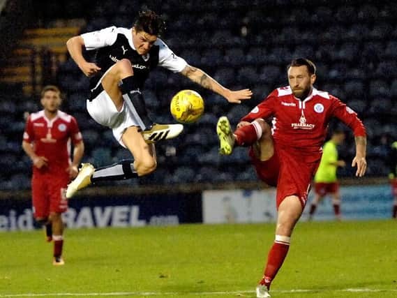 Ross Callachan flies into a challenge with Queens Stephen Dobbie. Pic: Fife Photo Agency