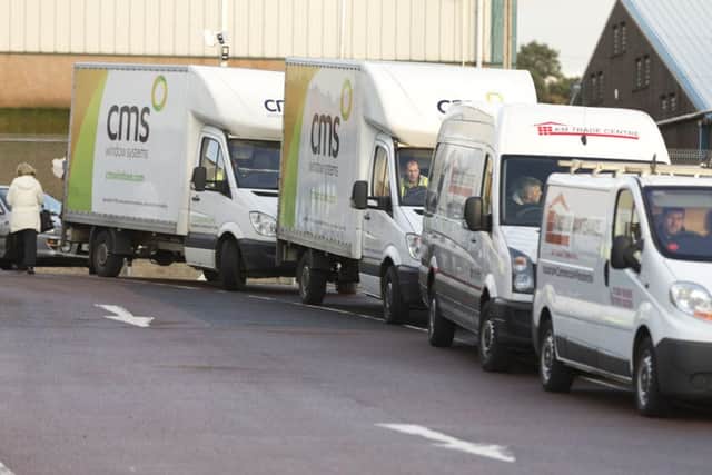 A convoy of vans sets off to deliver the packs to families. Pic by Stuart Wallace