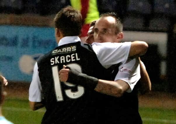 Mark Stewart, wearing a splint over his broken wrist, celebrates his winning goal against Queen of the South with Rudi Skacel. Credit- Fife Photo Agency