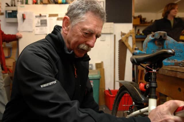 John Alexander fixes up an old bicycle
