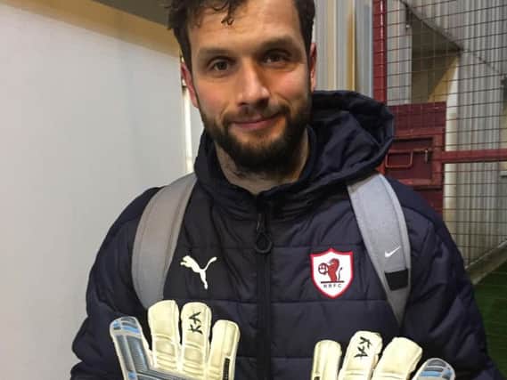 Raith goalkeeper Kevin Cuthbert with his signed Fife derby gloves.