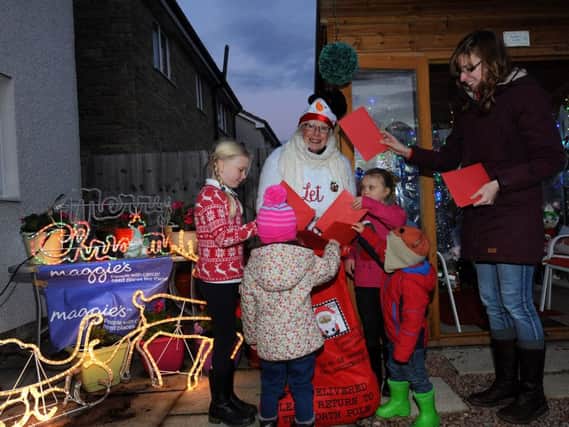 Heather Leuchars with local children in her Elves' workshop. Pic by FPA