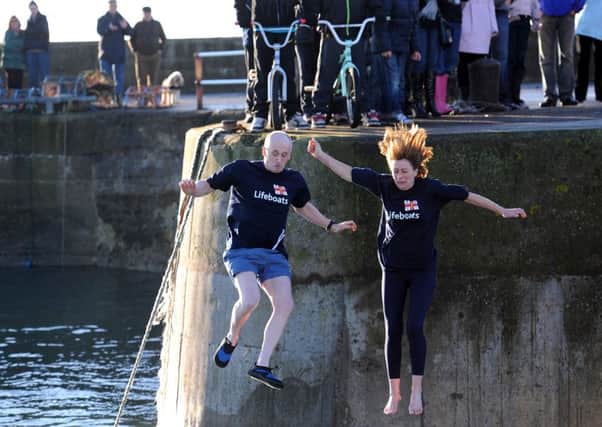 Kevin Corps and Jackie Sutherland take the plunge in a previous East Neuk Dook (picture by Walter Neilson)