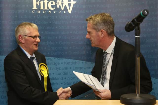 Steve Grimmond,  chief executive, Fife Council, congratulates Alistair Suttie, winner of the Leven, Largo & Kennoway by-election