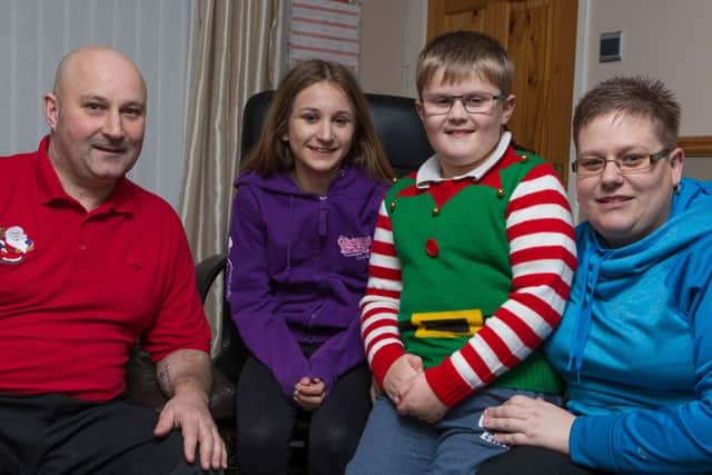 Pictured: (Left) William (51), Chelsea (12), Conner (9) and Louise Bermingham (36) at home in Glenrothes. Pic: Steven Brown