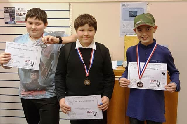 Winners of the first Glenwood Library Chess Club tournament. From left, Kuba Wolowinski, who won the silver medal; Dylan Webster, who had the highest score and took the gold medal; and Mitchell Colville, who won the bronze medal.