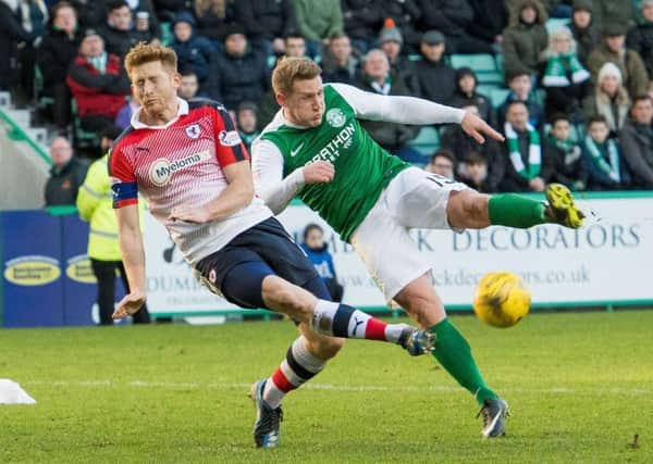 Jason Thomson makes a superb block from Kris Commons in the first half at Easter Road on Saturday. Pic: Ian Georgeson.