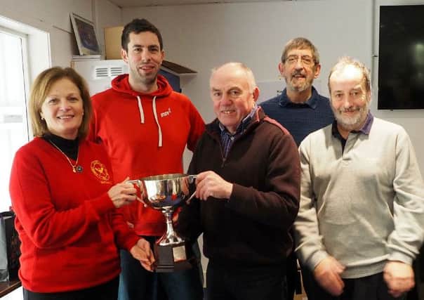 Forret Curling Club president Sheila Bell presenting the Otago Trophy to the winners of the New Year Bonspeil.
