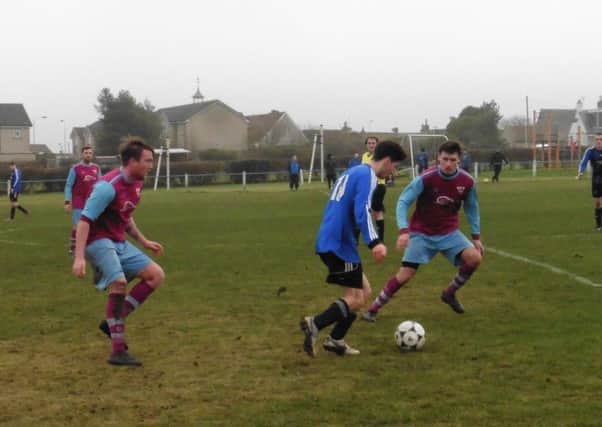 Cupar Hearts work to win back the ball.