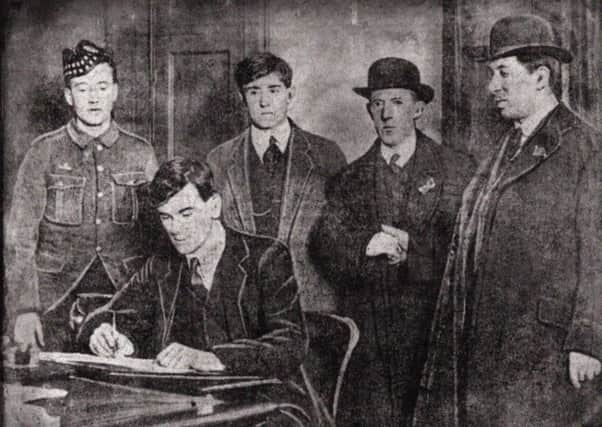 Raith Rovers vice-captain, George McLay, signing his enlistment papers for McCraes Battalion in the Tynecastle boardroom