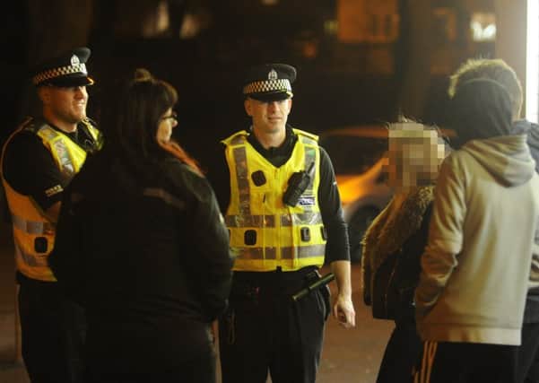 Police and youth workers talk to youths on Friday night. Pics by George McLuskie