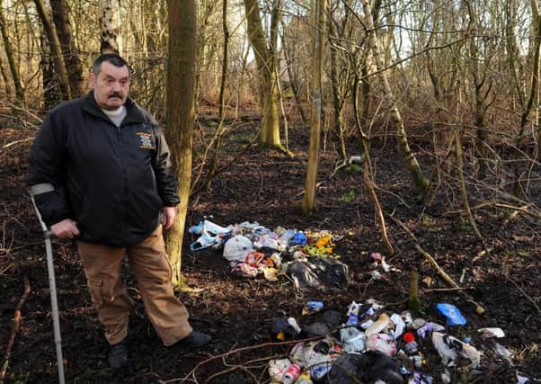 Community councillor 
Peter Scobie at the site of the repeated  fly tipping in Glenrothes. (Pic Fife Photographic Agency).