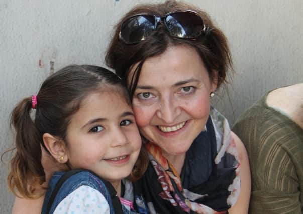 Donna with one of the Syrian children.