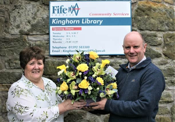 Tricia Dakers, Kinghorn's librarian is presented with flowers from Alan McIlravie of the Royal Burgh of Kinghorn Community Council in recognition of her service to the community as the service was closed on February 28.