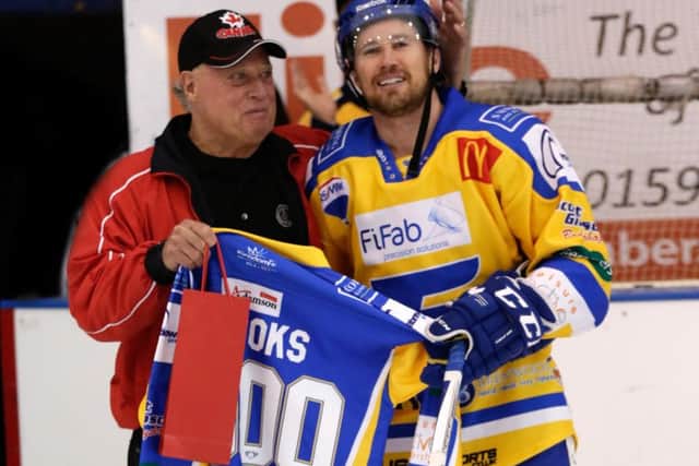 Fife Flyers' Brendan Brooks is presented with a '1000' jersey from his father, Larry, after making his 1,000th appearance in professional ice hockey  (Pic: Steve Gunn)