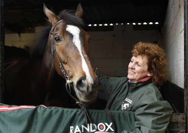 Grand National winner One For Arthur pictured with trainer Lucinda Russell at her yard near Kinross today.
