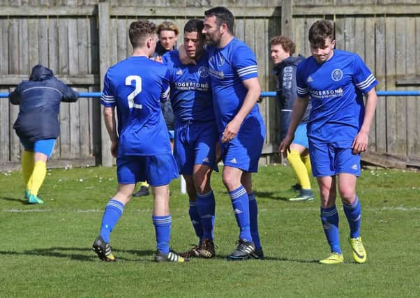 Dundonald scorer Barry Sibanda (second from left) is congratulated by his team mates. Pic: Dave Scott