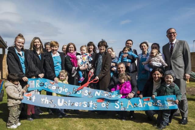 Principal Professor Sally Mapston, with children and staff, cuts the ribbon to officially open the university's new nursery. (Picture: Alan Richardson.)