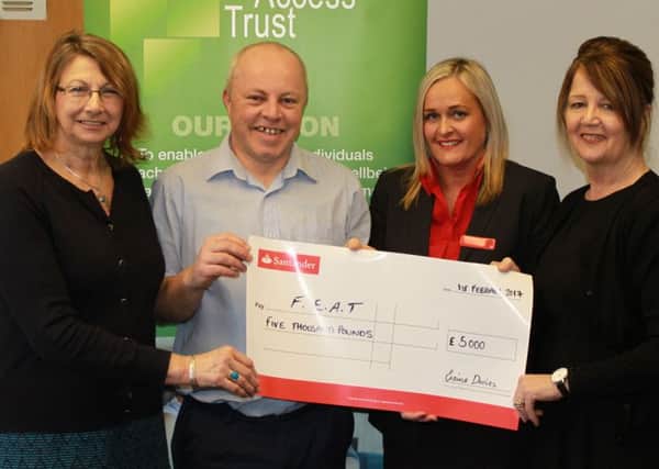 Funding boost...Duncan and the FEAT team receive the bumper cheque from Santander representatives.