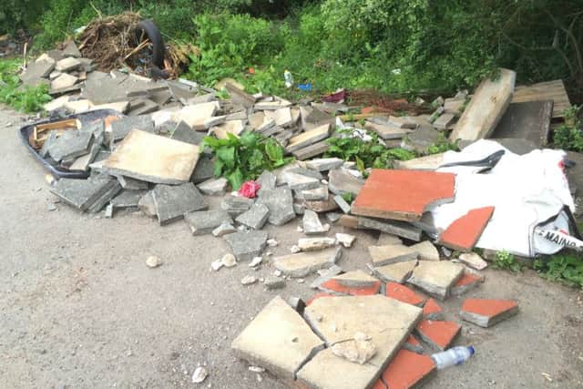 Builders rubble dumped by the roadside.