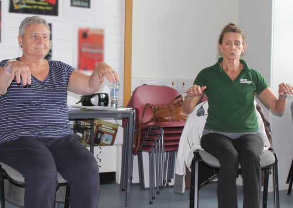 Fife Sports and Leisure Trust volunteer Liz Howie (right) with Move More Fife participant Denise Federico taking part in a gentle movement class.