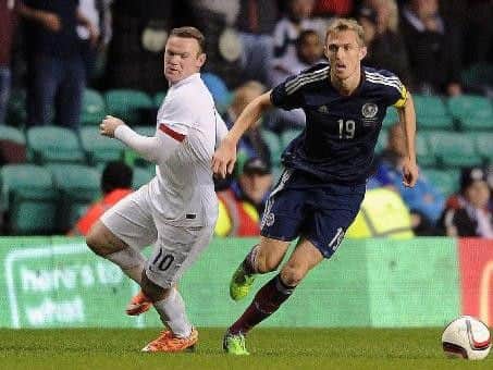 Wayne Rooney in action against Scotland's Darren Fletcher (Pic by John Devlin)