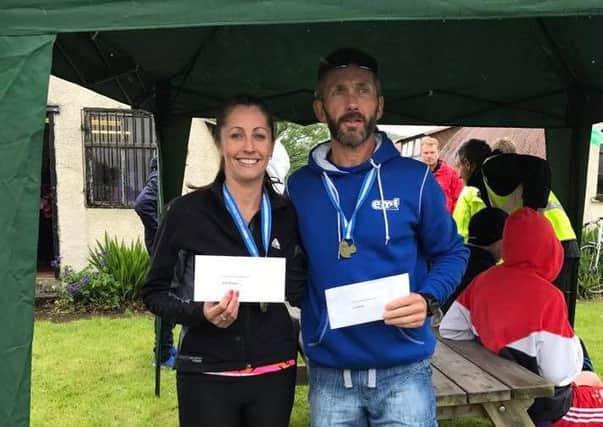 Andy Lafferty and Zoey Johnston with their prizes following the Strathearn Marathon.