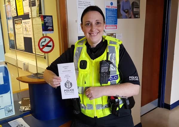 PC Kerry Anderson with the latest Signpost to Safety campaign leaflet.