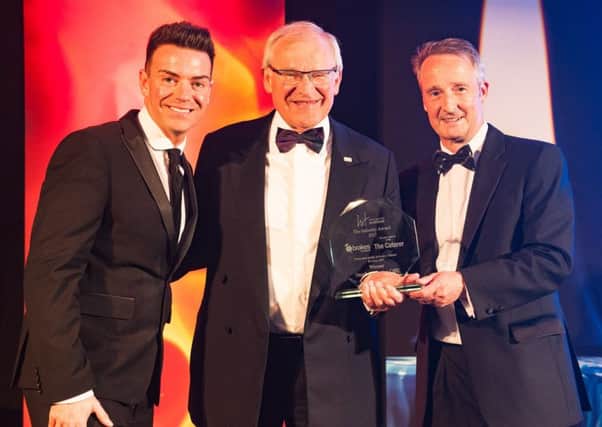 Stephen Carter, centre, accepts his award (picture by Simon Williams)