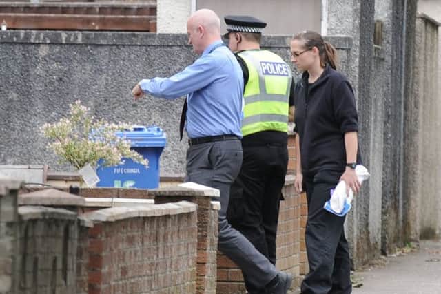 Investigating officers continue their search of a house in Barton Place, Glenrothes. (Pic George McLuskie).