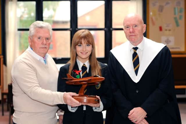 Clem O'Mara presents the Flt Lt Mike Withey Bravery Award to pupil Ellie Cunningham, watched by Rector Derek Allan Picture: FPA
