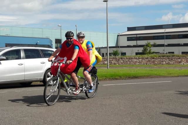 Two of the cyclists dressed as M&Ms.