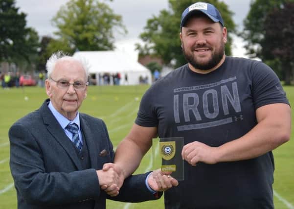 Thronton's chieftain Adam Crawford presents overall heavy events winner Sinclair Patience, right, from Tain, with his prize (picture by Ian Grieve)