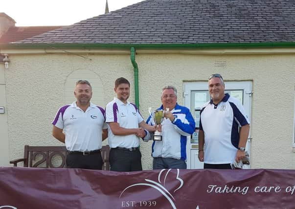 The winning trio collect their trophy from club president Garry Campbell.