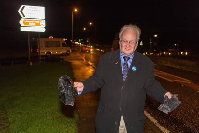 Councillor David MacDiarmid with some of the debris left from what he says are almost daily accidents on the stretch of road.