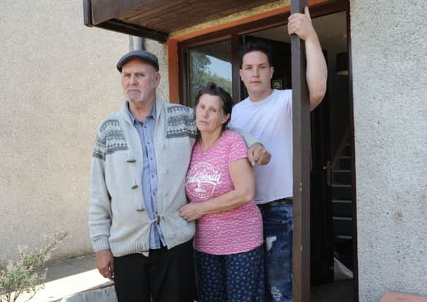 Thomas and Elizabeth McAllister with her son Thomas at the family home which police have spent the last 33 days searching. (Pic George McLuskie).