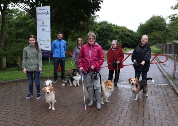 Dog walkers, led by Denise Wallace, centre, are calling on a dedicated safe space to walk their pets at the popular Fife park. (Pic David Cruikshanks).